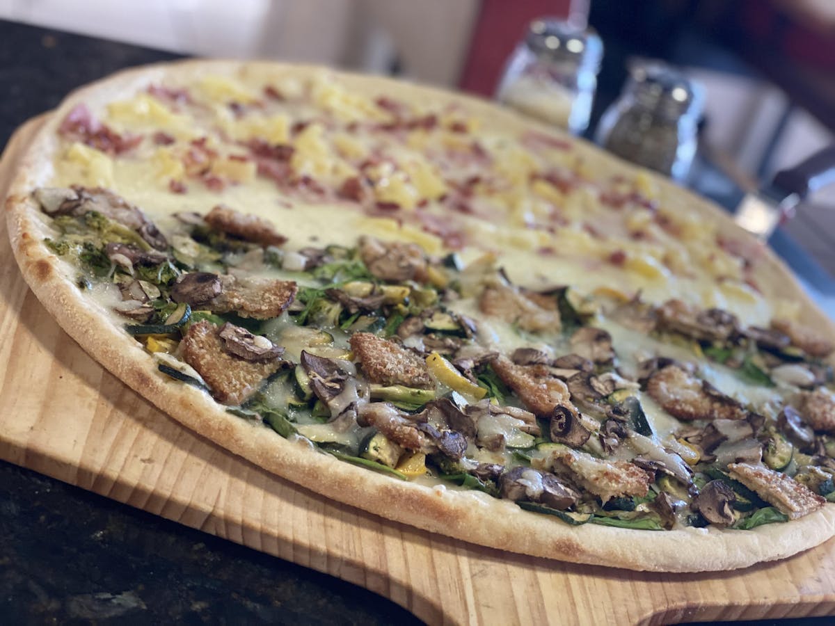 a pizza sitting on top of a wooden cutting board